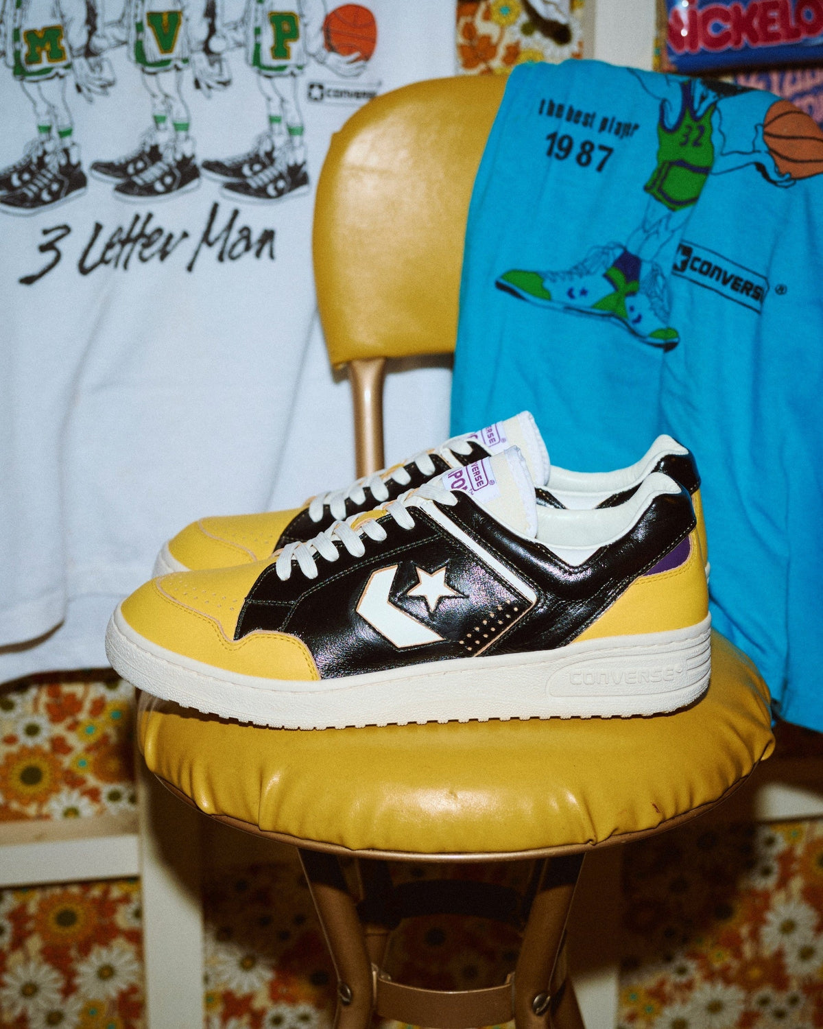 Converse Weapon J VTG 40TH OX MAGFORLIA Black/Gold on yellow vintage chair with retro Converse basketball tees, official Converse Japan TimeLine press