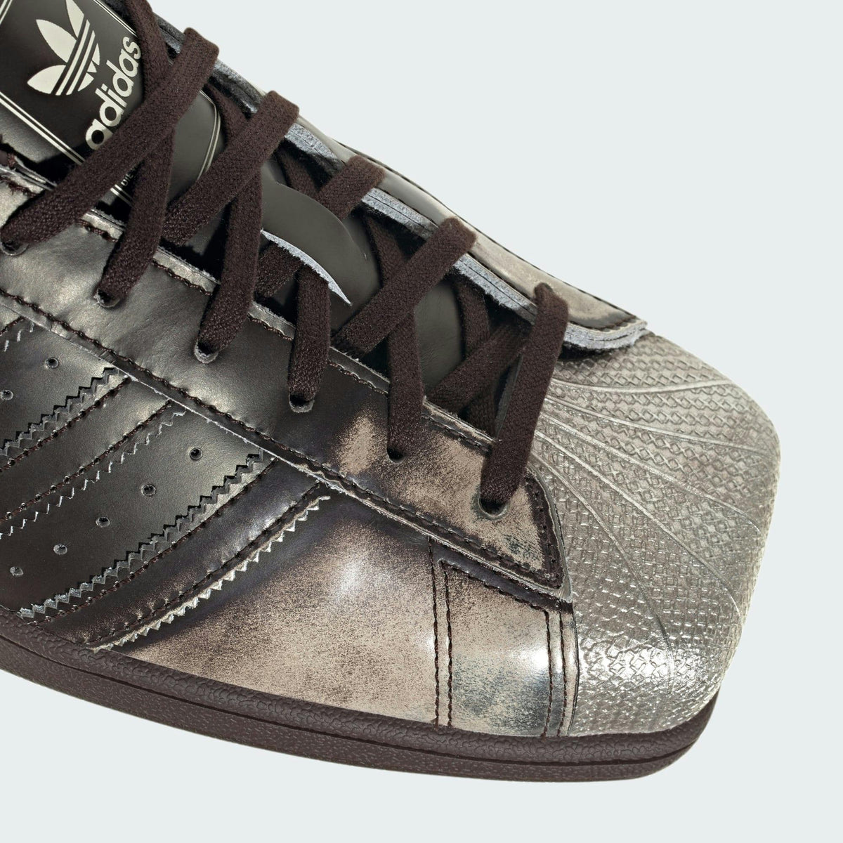 adidas Superstar SQ “Aurora Coffee/Silver Metallic” close-up of squared metallic shell toe, official press