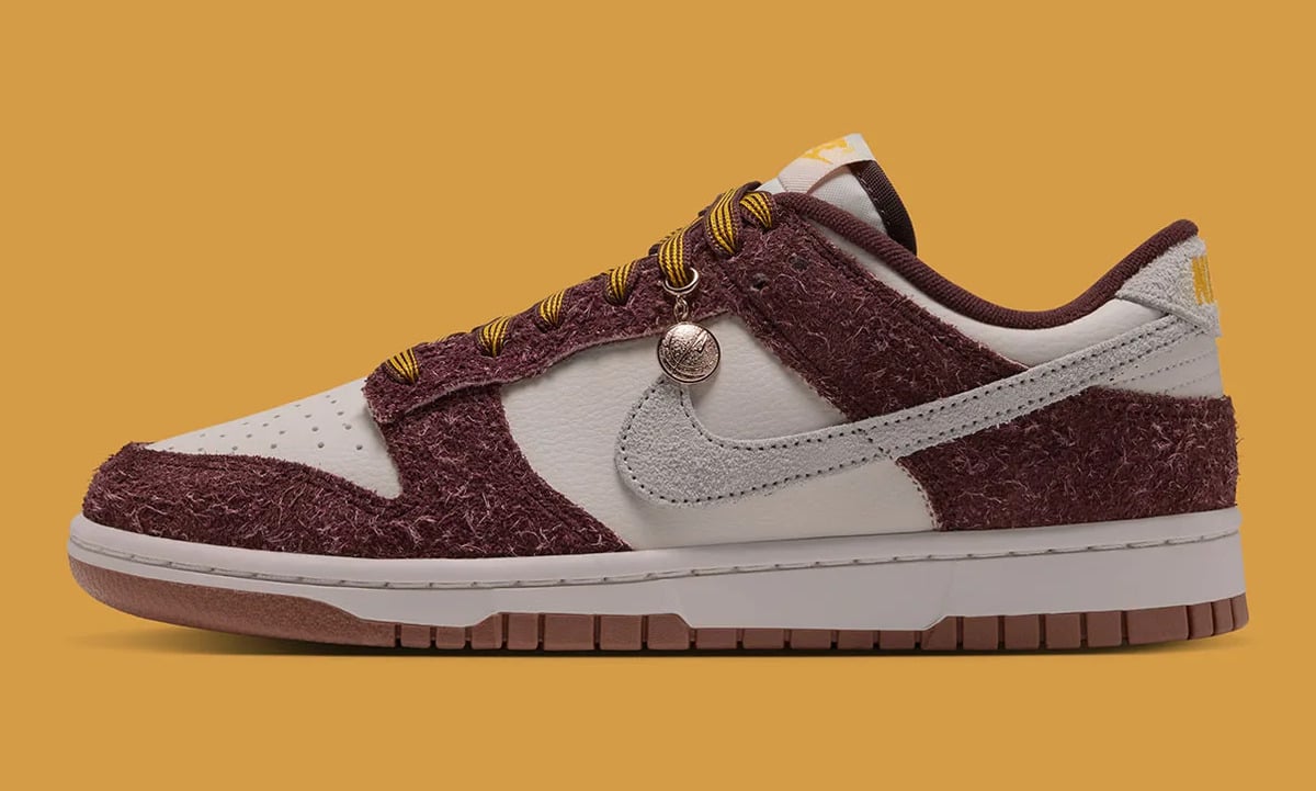 Women's Nike Dunk Low Basketball Charm JA3772-658 in Mystic Dates hairy suede with a metal basketball lace charm, lateral view. Image via Nike / JustFreshKicks