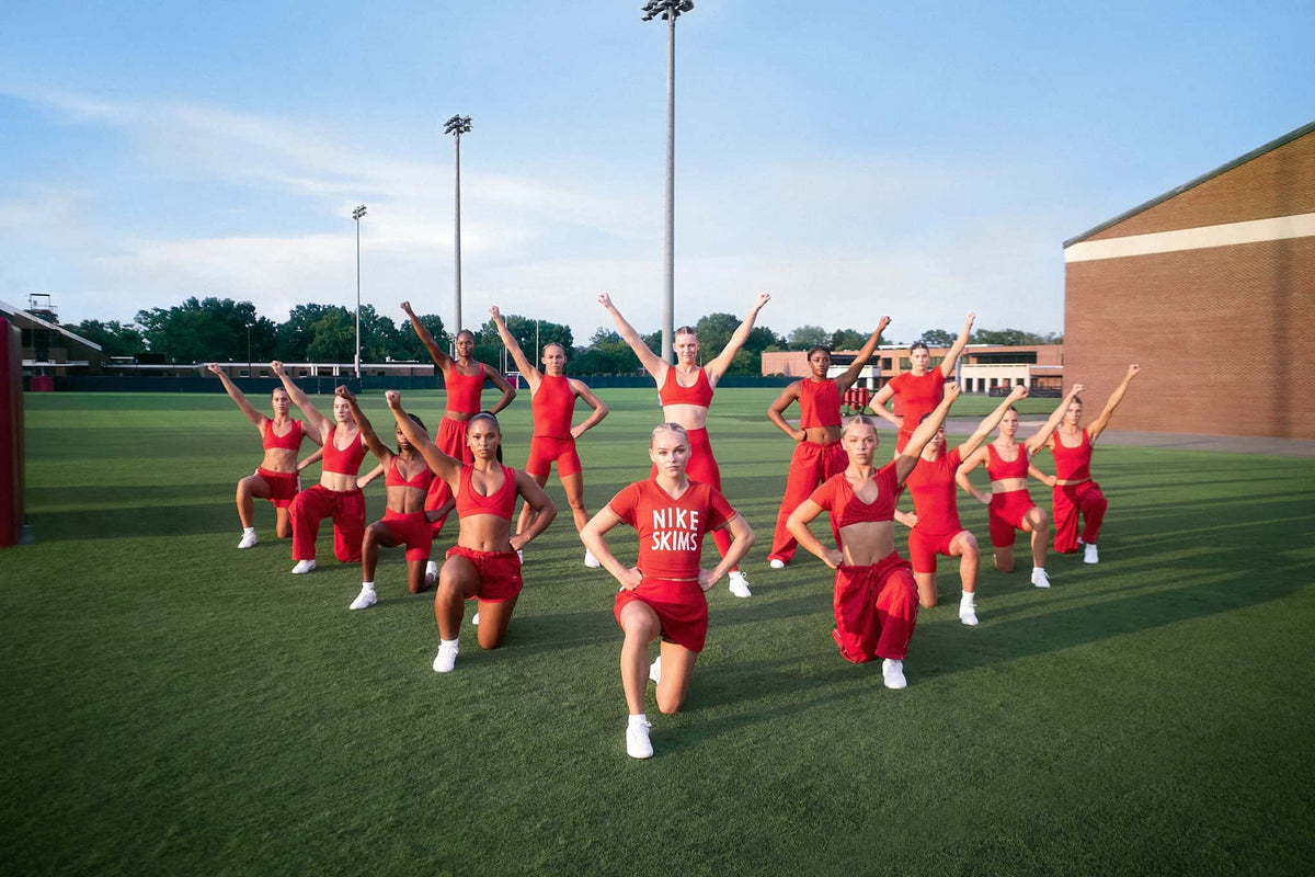The University of Alabama cheer team in University Red NikeSKIMS on a football field. Photo: Nike