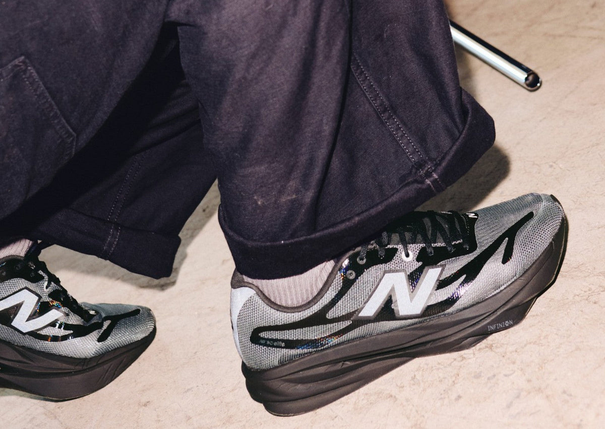 Dover Street Market x New Balance SuperComp Elite v6 in light grey and black on foot. Photo via Sole Retriever
