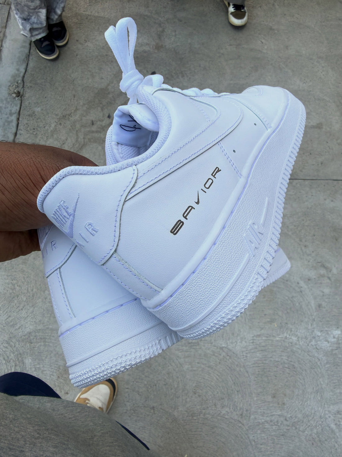 Jae Tips × Nike Air Force 1 Low Savior heel laser held outdoors — ComplexCon 2026