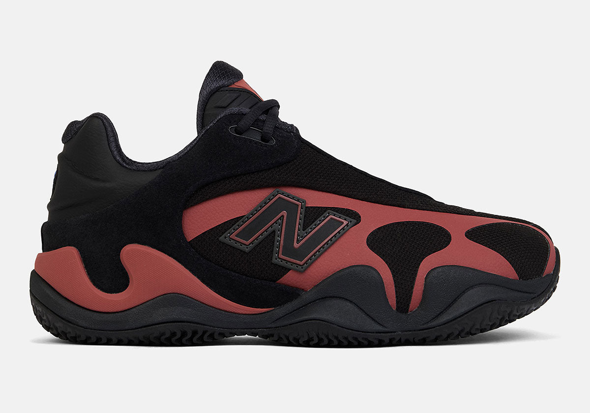 New Balance Maxey v1 in black with Red Rock overlays, lateral side view. Official image via Sneaker News