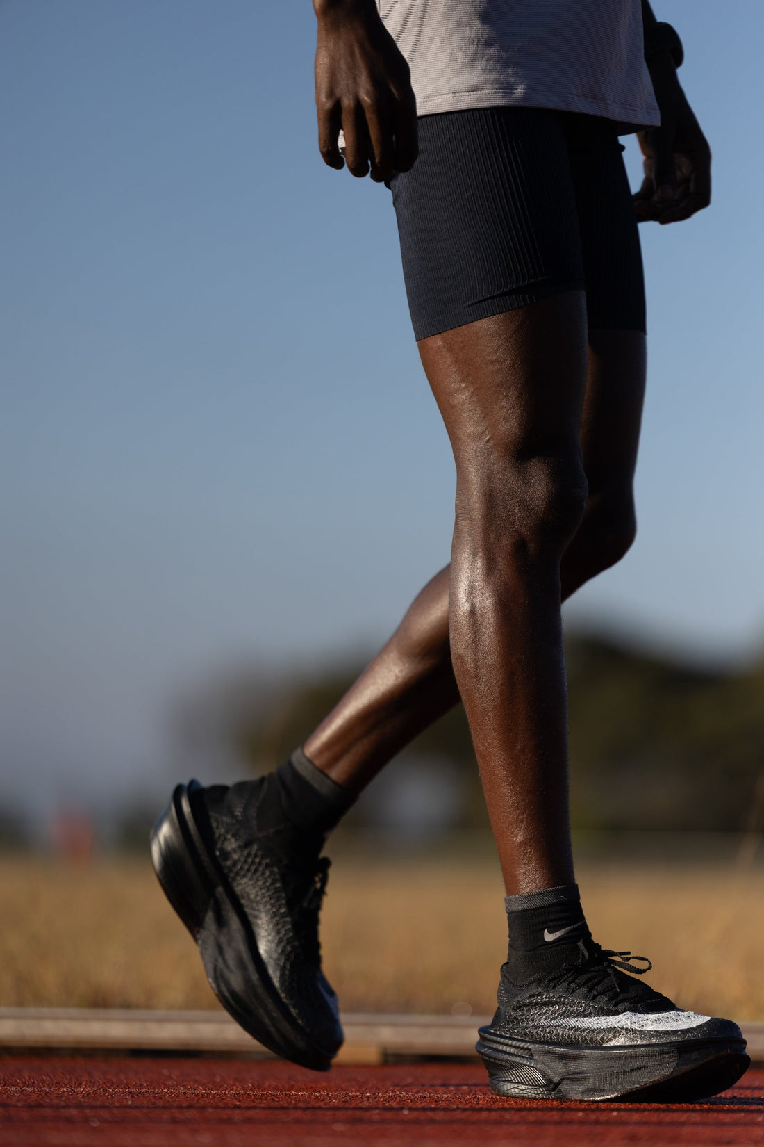 Jacob Kiplimo mid-stride on a red track in Nike Apex marathon racing shoes — official Nike newsroom