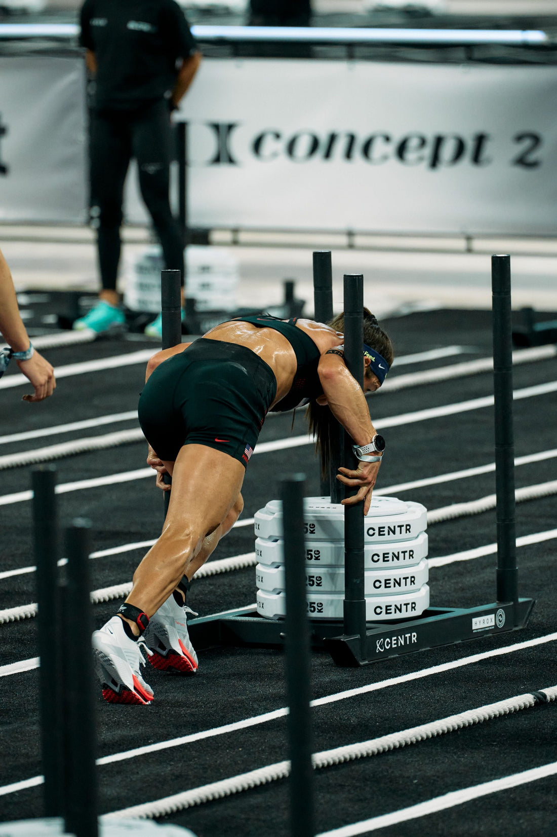 Lauren Weeks pushes a HYROX sled in Nike Hybrid footwear — official Nike newsroom