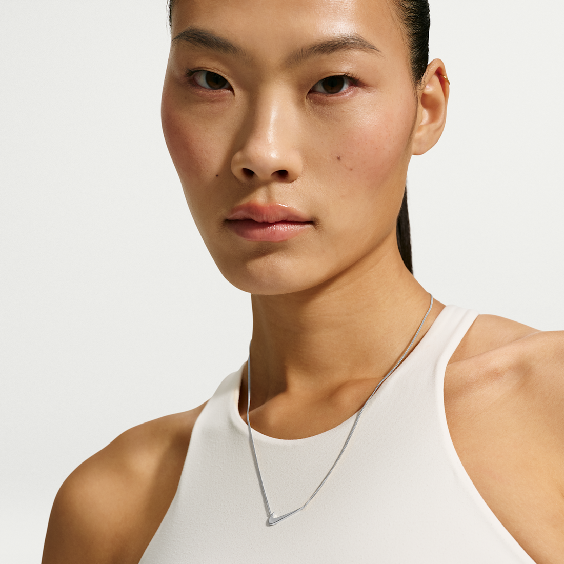 Nike Mini Swoosh Necklace in silver — on-model campaign — official Nike