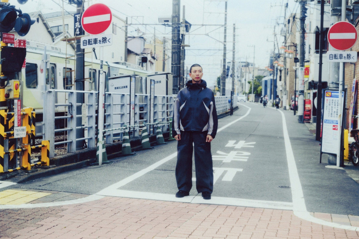 Model in the Nike Tech SF3 waterproof jacket standing on a city street. Photo courtesy Nike