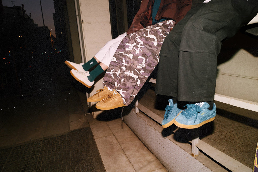 PUMA Suede Forever campaign — three on-model colorways on a night ledge — official Media Hub